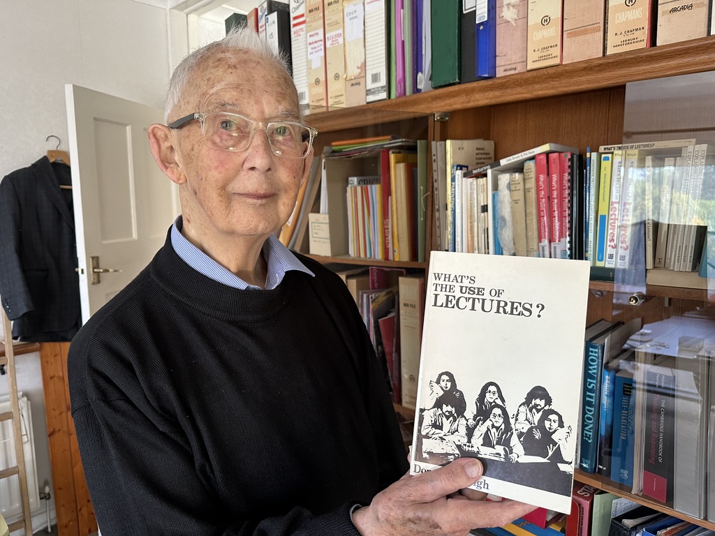 Donald Bligh holding his book What's the Use of Lectures?